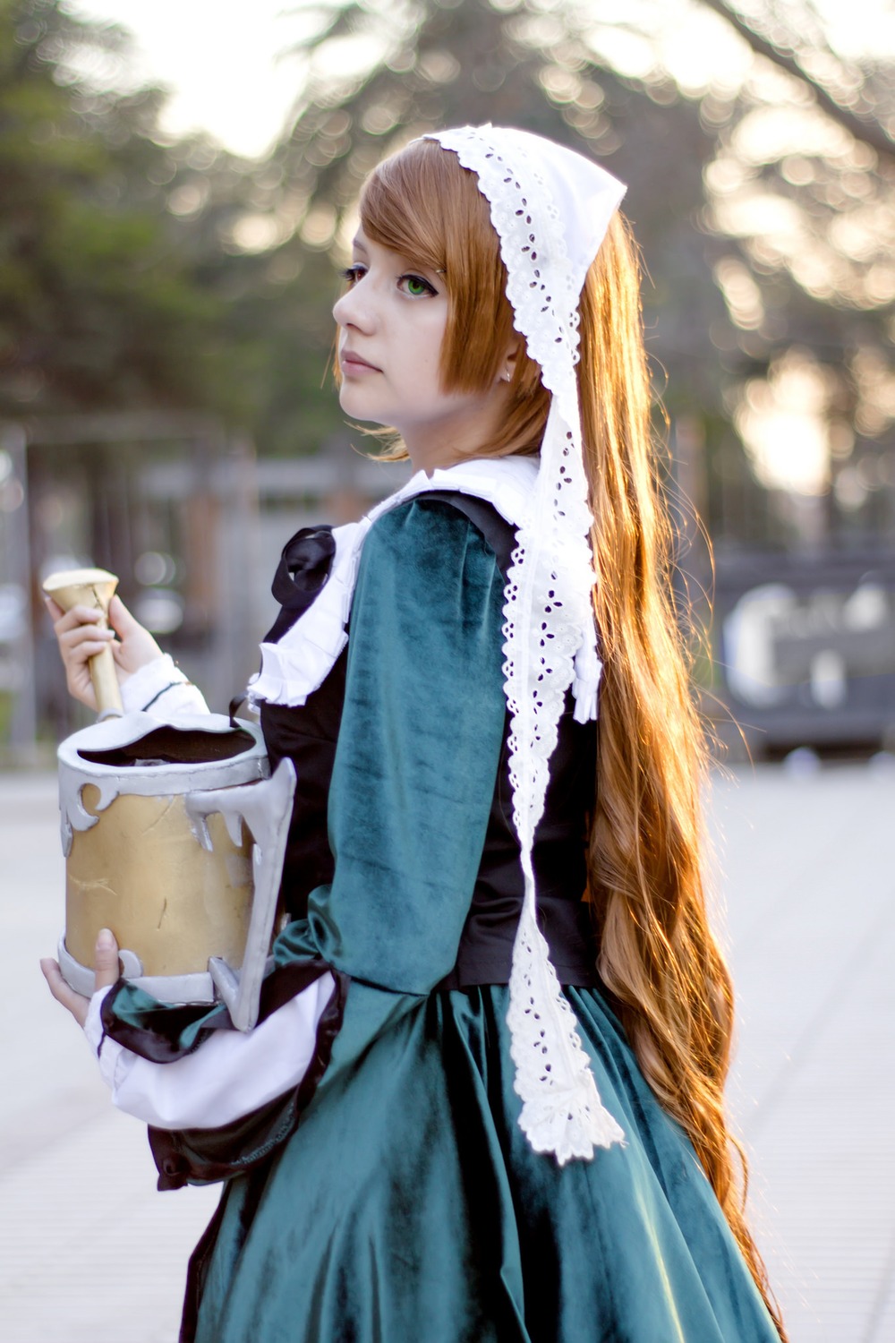 1girl apron blonde_hair blurry blurry_background depth_of_field dress green_dress green_eyes long_hair long_sleeves outdoors snow solo suiseiseki