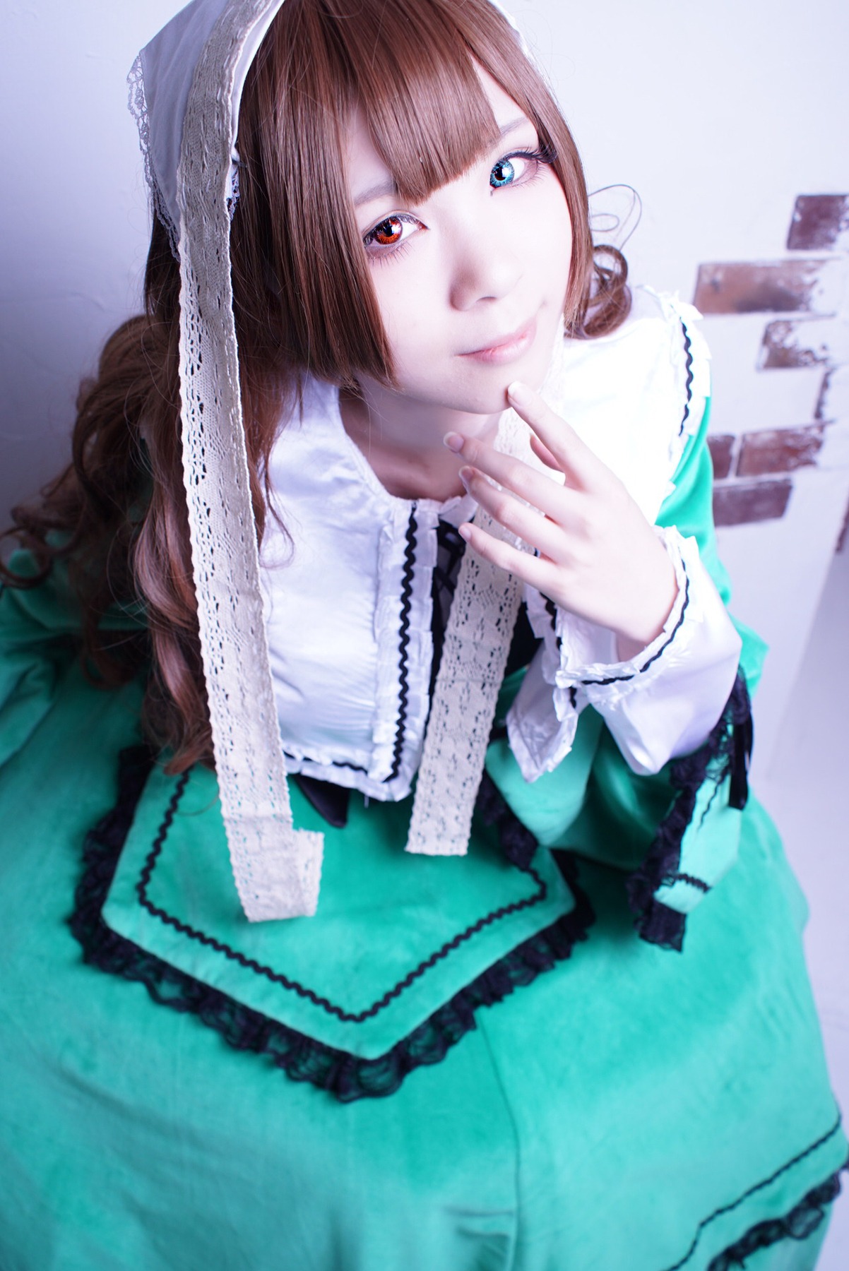 1girl bangs blue_eyes blunt_bangs brown_hair dress earrings frills green_dress heterochromia jewelry lips lolita_fashion long_hair looking_at_viewer red_eyes solo suiseiseki