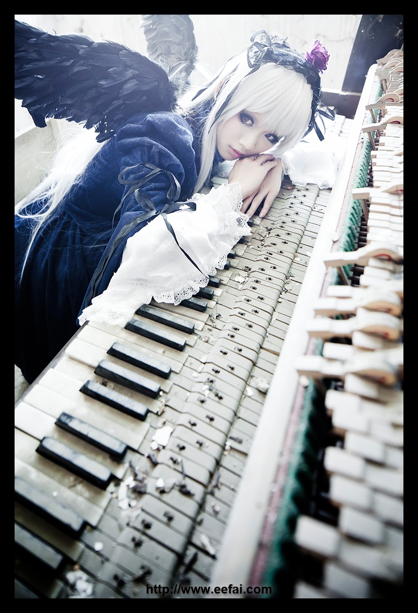 1girl black_border blue_eyes blurry depth_of_field dress feathers frills hair_ornament letterboxed nail_polish pillarboxed solo suigintou white_hair wings
