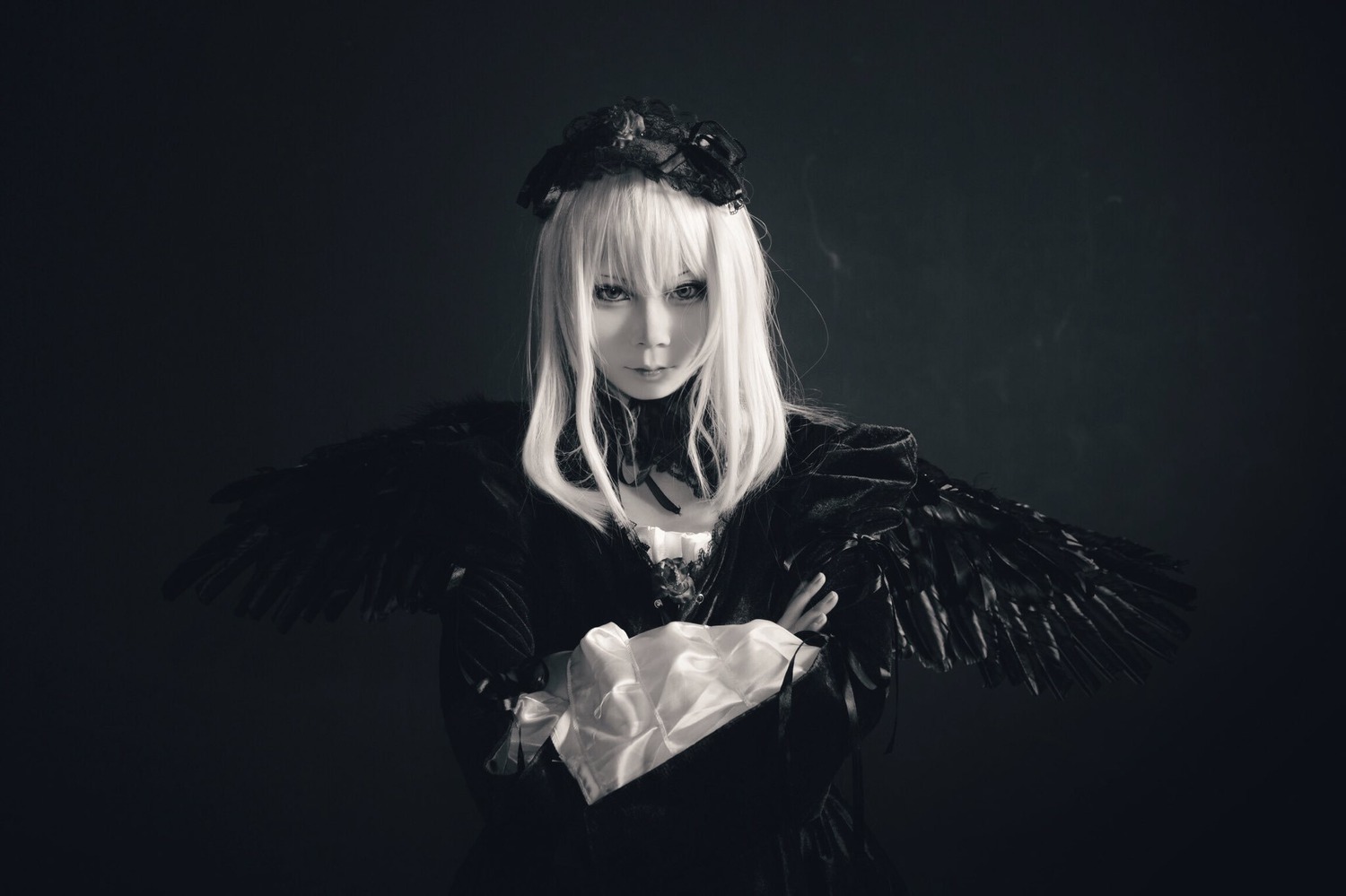 1girl bangs black_background black_wings closed_mouth crown dress feathered_wings long_hair long_sleeves looking_at_viewer monochrome solo suigintou upper_body wings
