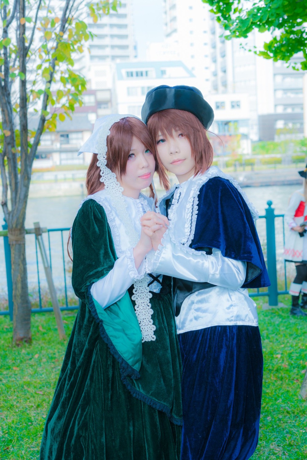 2girls blue_eyes brown_hair building dress hat holding_hands looking_at_viewer multiple_cosplay multiple_girls outdoors siblings sisters smile standing tagme