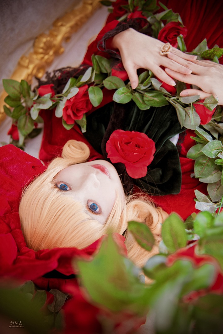 1girl bangs blonde_hair blue_eyes blurry depth_of_field dress flower hands holding_flower jewelry lips looking_at_viewer red_flower red_lips red_rose ring rose shinku solo upper_body