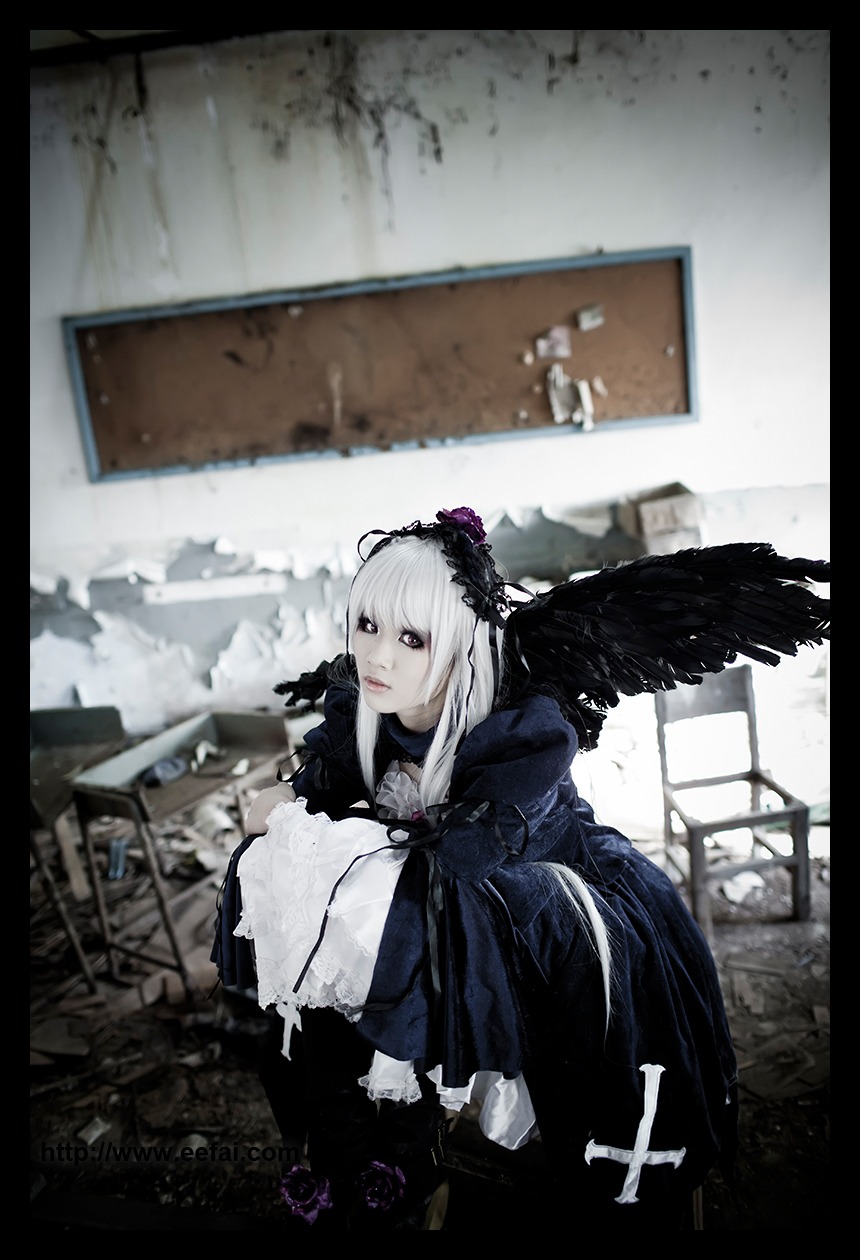 1girl black_border black_wings blurry depth_of_field dress feathers frills indoors letterboxed long_sleeves looking_at_viewer solo suigintou wings