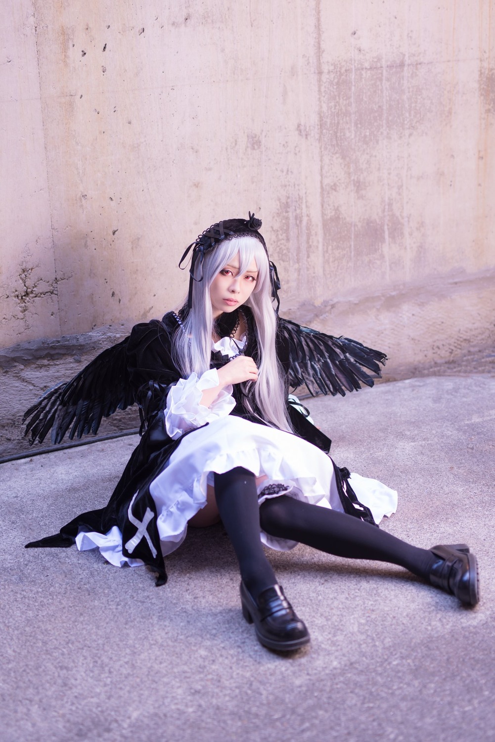 1girl black_footwear black_legwear black_ribbon black_wings boots dress flower frills hairband long_hair long_sleeves looking_at_viewer ribbon rose silver_hair sitting solo suigintou wings