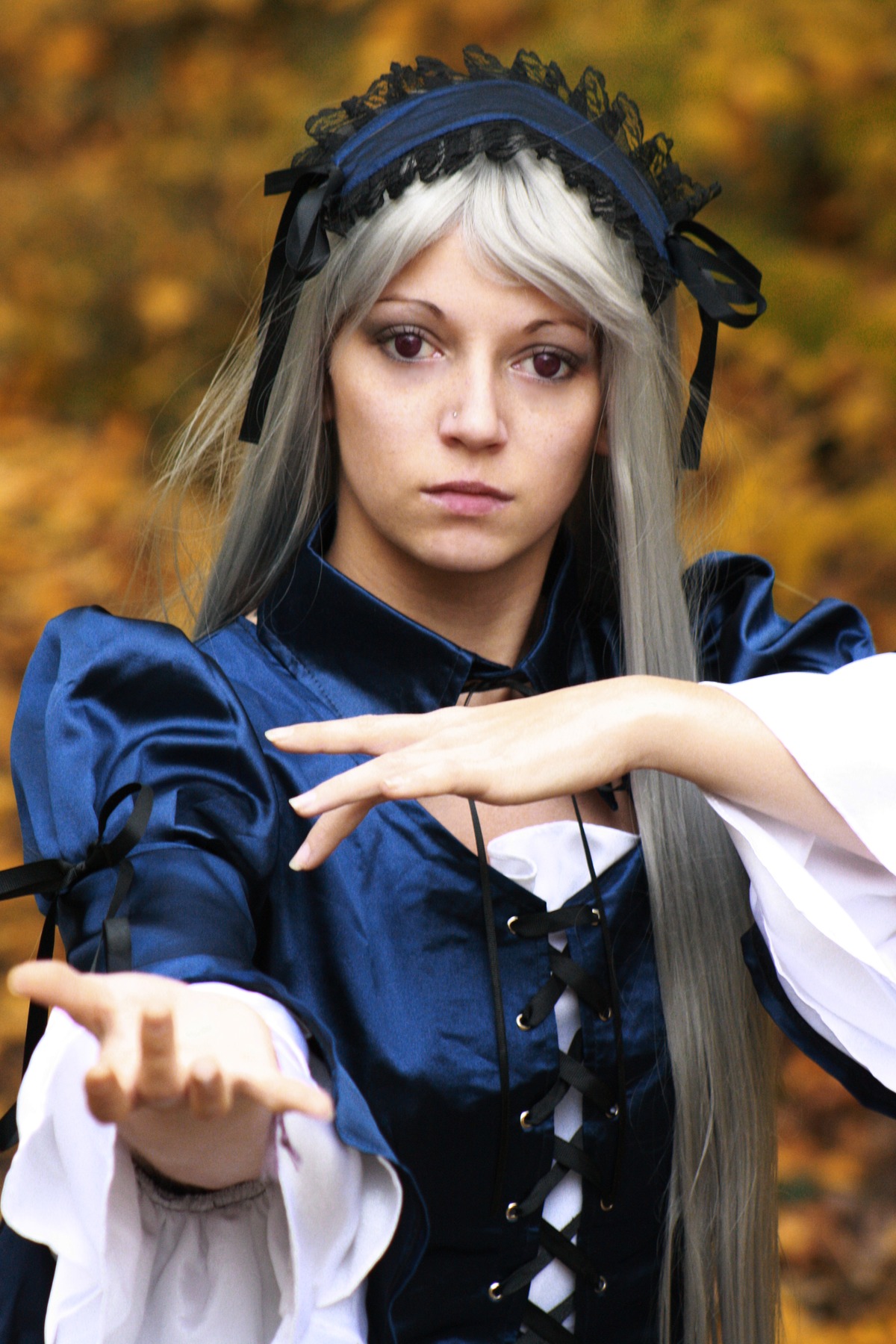 1girl auto_tagged blurry blurry_background blurry_foreground closed_mouth depth_of_field dress hairband lips lolita_hairband long_hair long_sleeves looking_at_viewer purple_eyes ribbon silver_hair solo suigintou upper_body