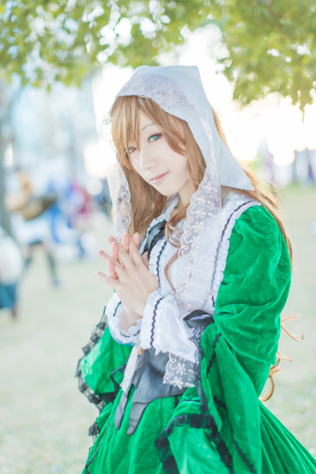 2girls blonde_hair blue_eyes blurry blurry_background blurry_foreground depth_of_field dress green_dress hood lips long_hair long_sleeves multiple_girls solo suiseiseki