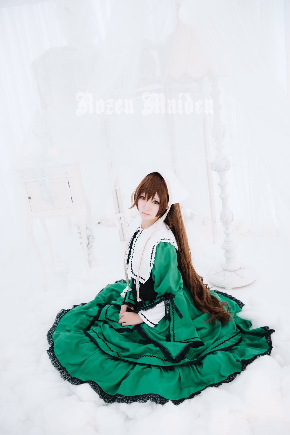 1girl brown_hair closed_mouth dress frills green_dress long_hair long_sleeves looking_at_viewer sitting skirt_hold solo suiseiseki very_long_hair