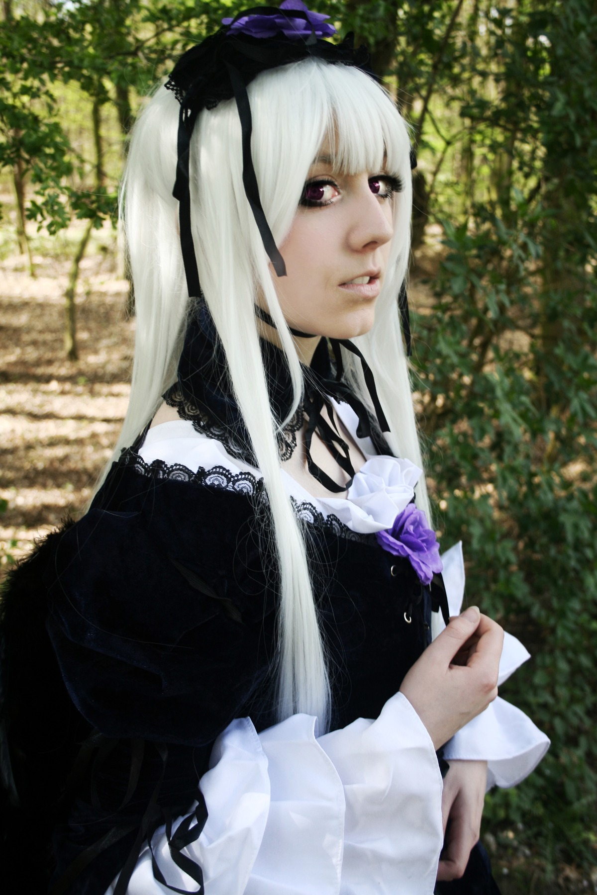 1girl auto_tagged black_dress bush dress frills gothic_lolita hairband lips lolita_fashion long_hair long_sleeves outdoors purple_eyes ribbon solo suigintou tree