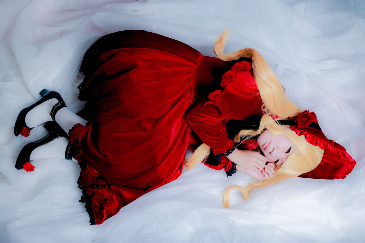 1girl blonde_hair bonnet closed_eyes dress flower long_hair lying on_side red_dress red_flower red_rose rose shinku shoes solo