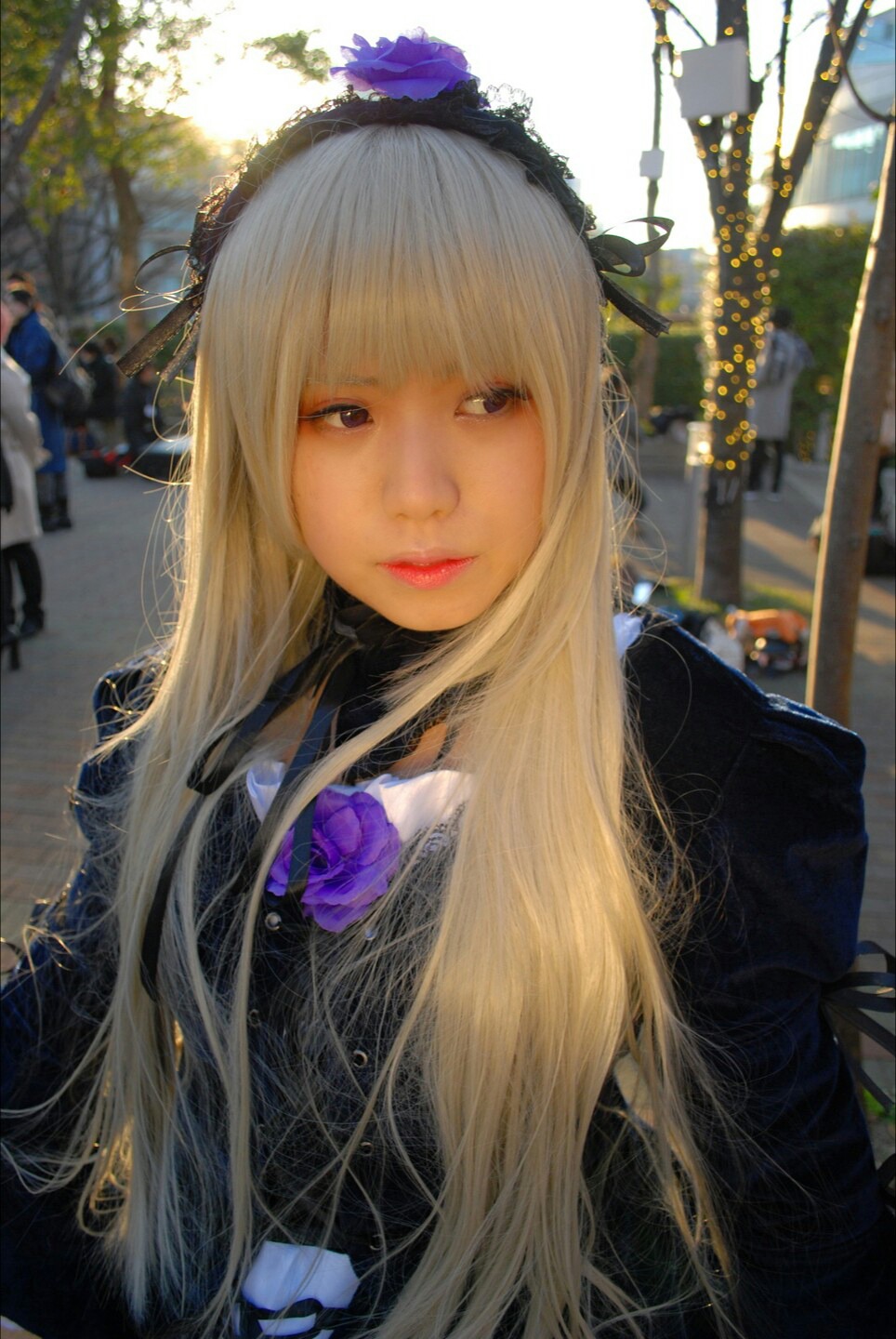 1girl bangs black_dress blonde_hair blue_eyes blurry blurry_background closed_mouth depth_of_field dress flower lips long_hair looking_at_viewer realistic solo suigintou upper_body