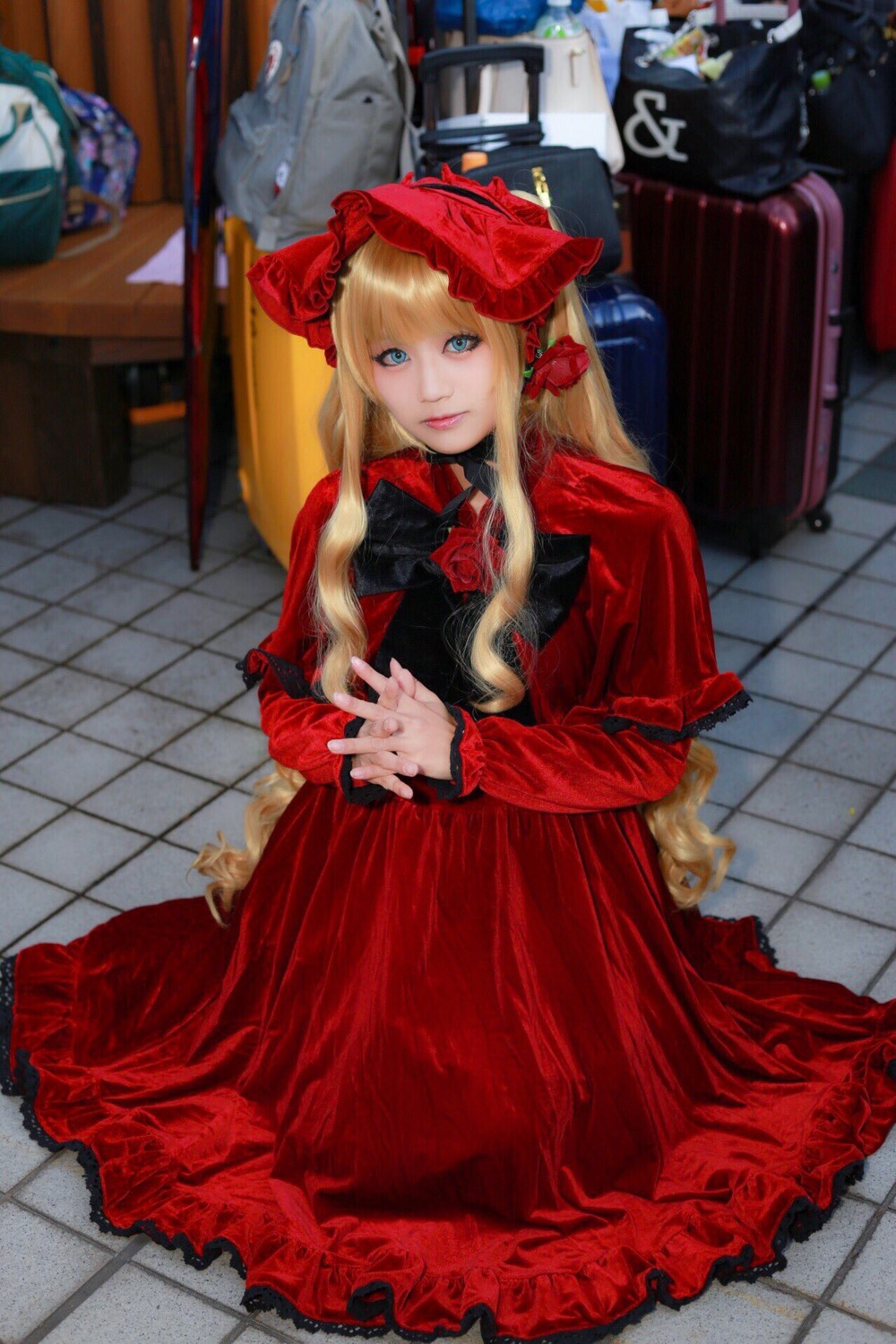 1girl blonde_hair blue_eyes bonnet dress flower long_hair long_sleeves looking_at_viewer red_dress rose shinku sitting solo tile_floor tiles