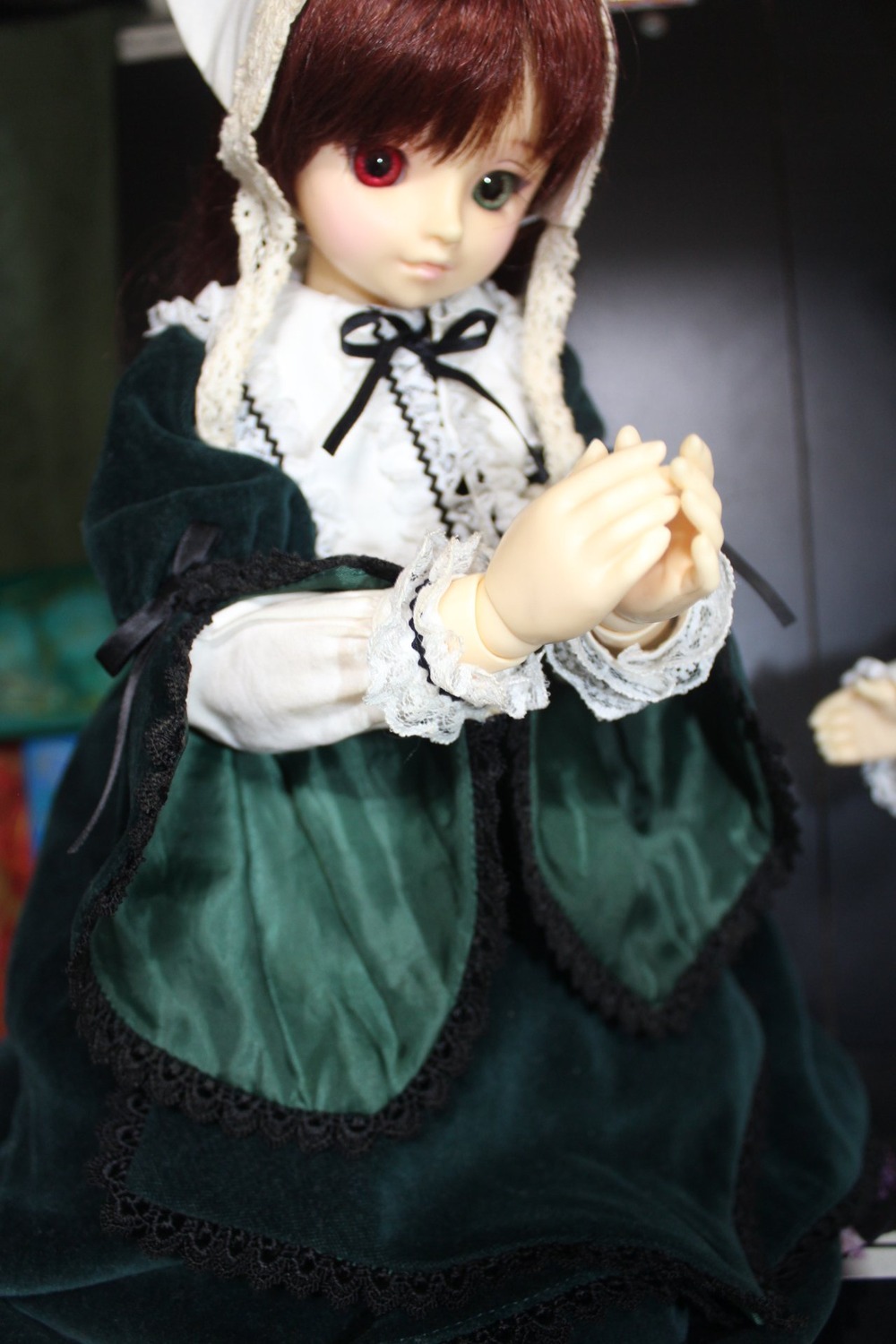 1girl blurry brown_hair depth_of_field doll dress frills gothic_lolita heterochromia holding_hands interlocked_fingers lace lolita_fashion long_sleeves looking_at_viewer out_of_frame red_eyes ribbon solo solo_focus suiseiseki