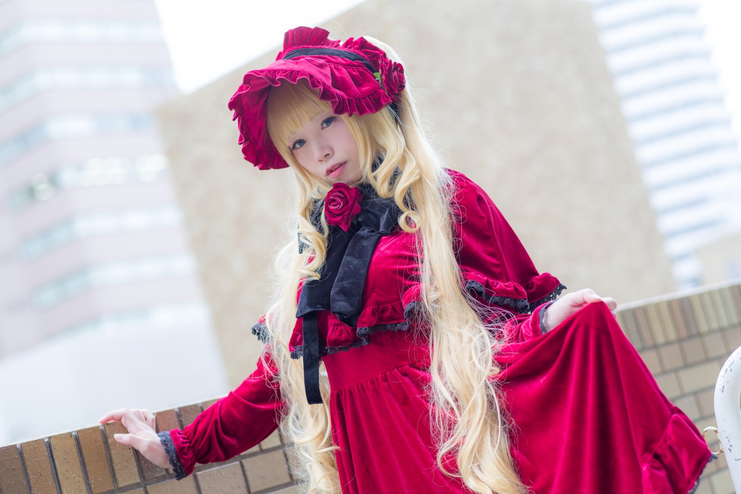 1girl bangs blonde_hair blue_eyes blurry blurry_background bonnet depth_of_field dress flower long_hair long_sleeves looking_at_viewer photo pink_flower pink_rose red_dress rose shinku solo very_long_hair