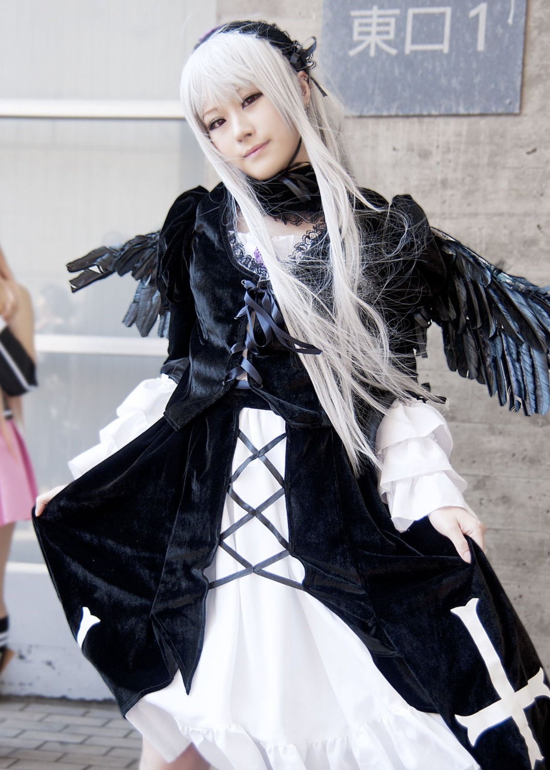 1girl black_dress blurry depth_of_field dress hairband long_hair long_sleeves looking_at_viewer photo solo solo_focus standing suigintou white_hair wings