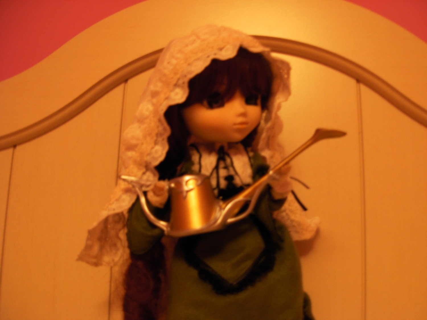 1girl bangs blurry depth_of_field doll dress holding_umbrella long_sleeves parasol sepia solo suiseiseki table umbrella