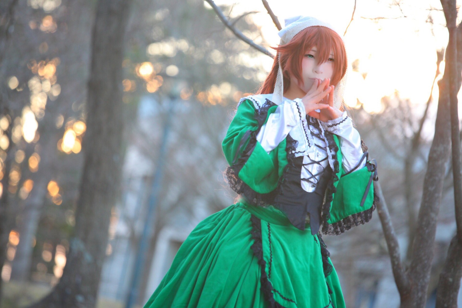 1girl blurry brown_hair depth_of_field dress green_dress green_eyes hat long_hair long_sleeves looking_at_viewer outdoors solo suiseiseki tree