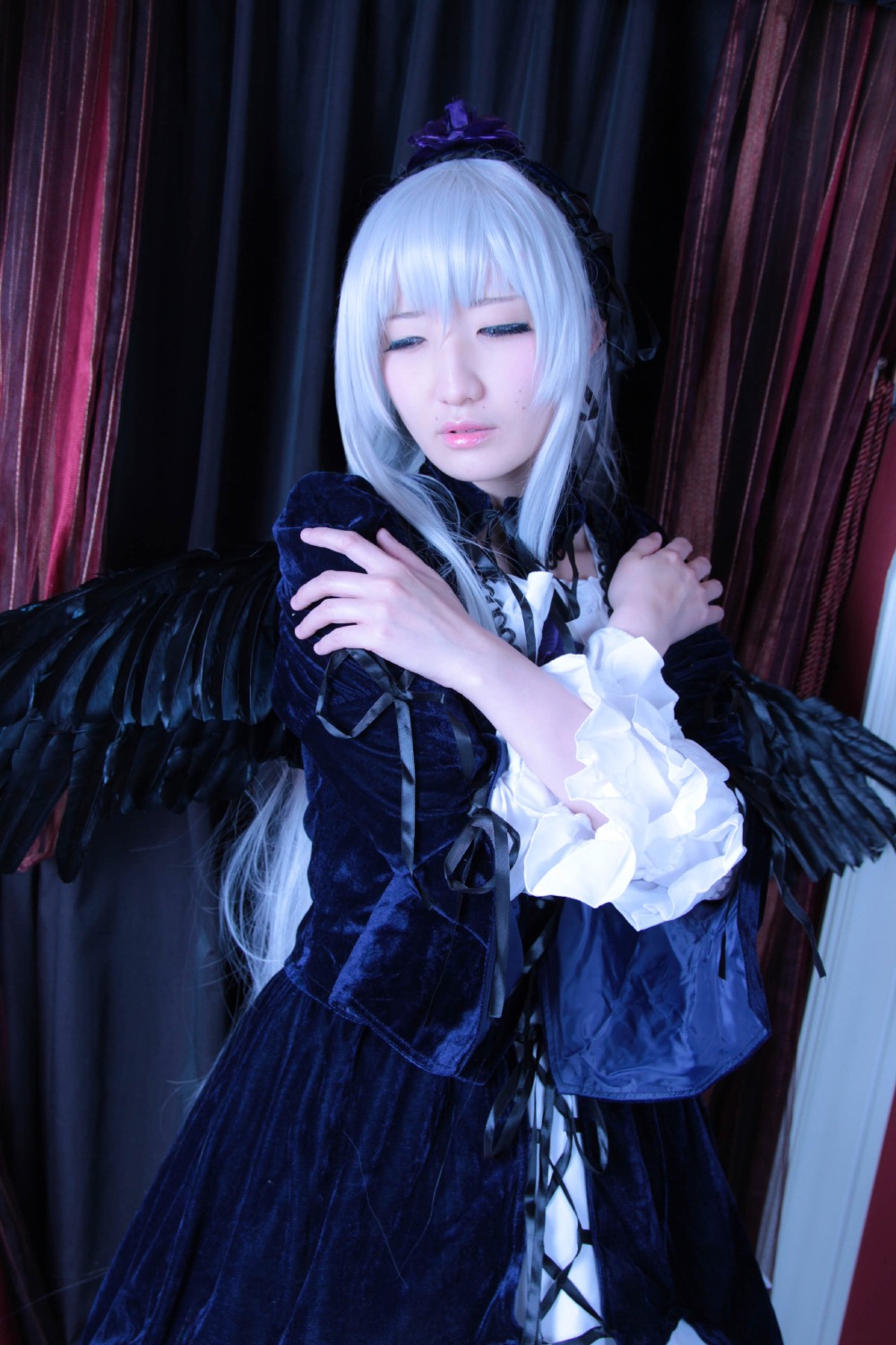 1girl bangs black_feathers black_wings closed_eyes closed_mouth curtains dress feathered_wings feathers frills indoors long_hair long_sleeves solo standing suigintou white_hair wings