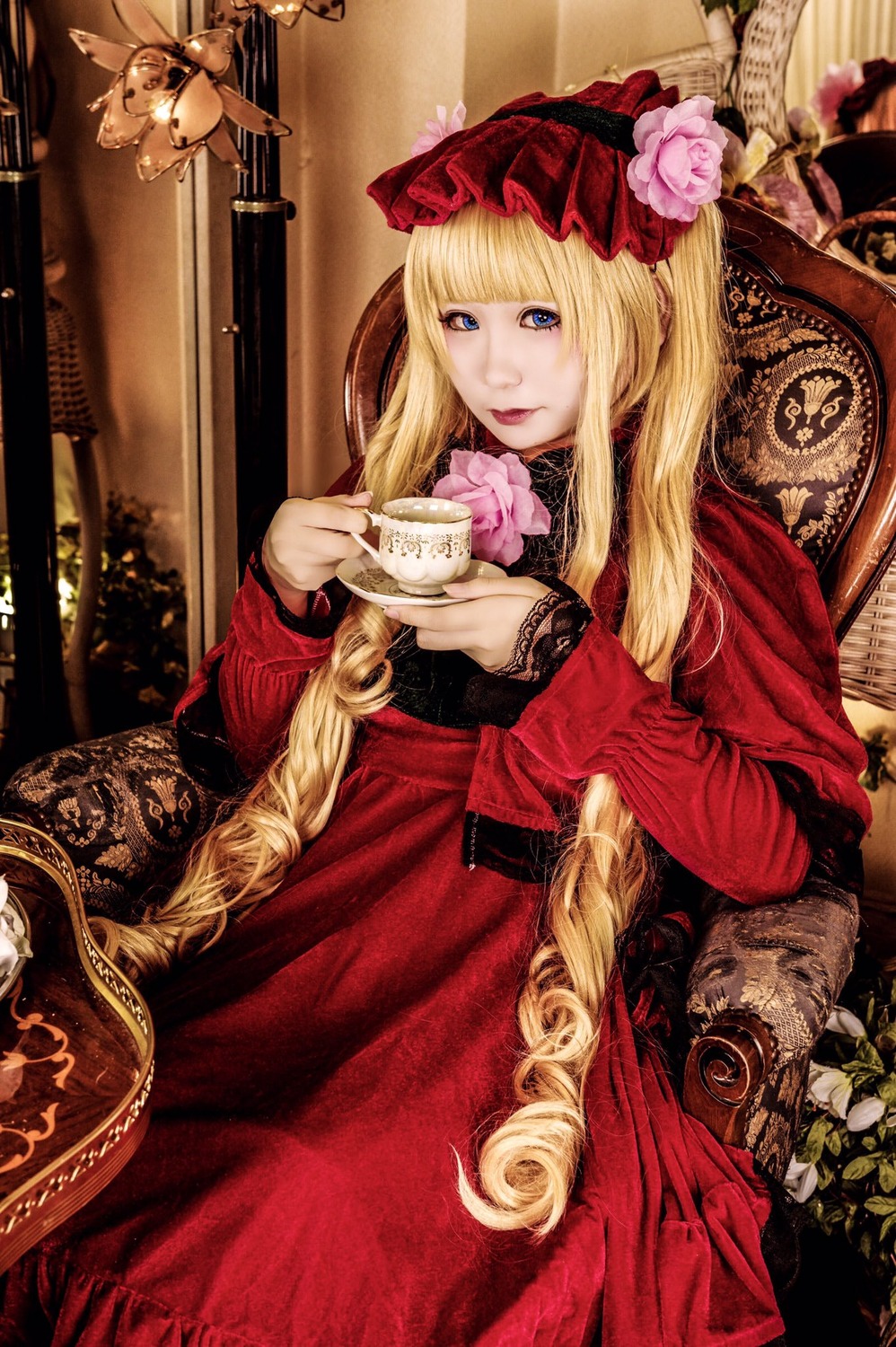 1girl blonde_hair blue_eyes bonnet cup dress flower food holding holding_cup lace long_hair looking_at_viewer red_dress rose shinku sitting solo teacup