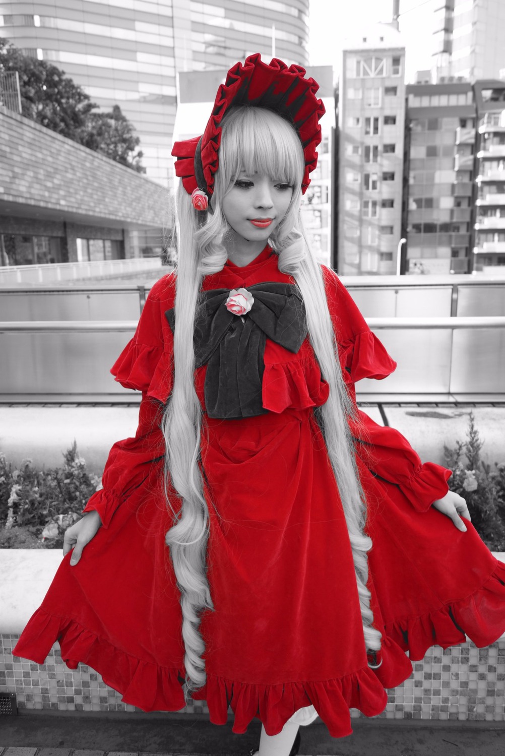 1girl building dress frills long_hair long_sleeves looking_at_viewer outdoors red_dress shinku smile solo standing very_long_hair