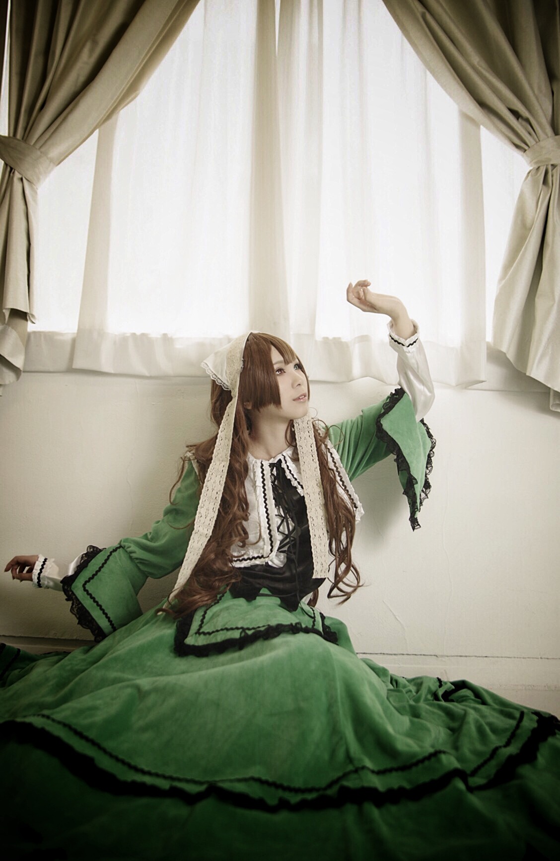 1girl brown_hair curtains dress green_dress indoors long_hair sitting solo suiseiseki window