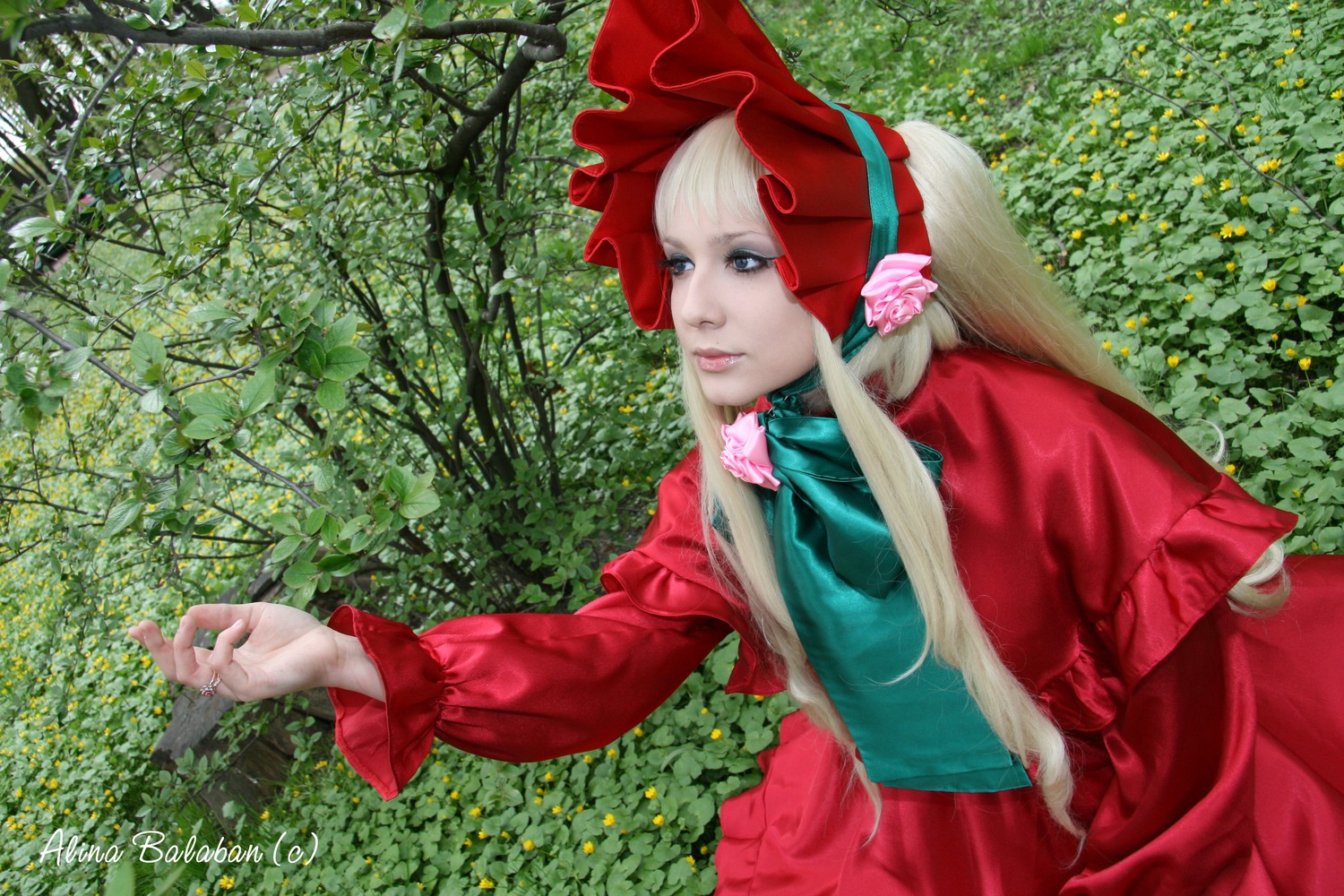 1girl artist_name auto_tagged blonde_hair blue_eyes bonnet bush capelet dress flower lips long_hair long_sleeves nature outdoors outstretched_arm red_capelet red_dress rose shinku solo