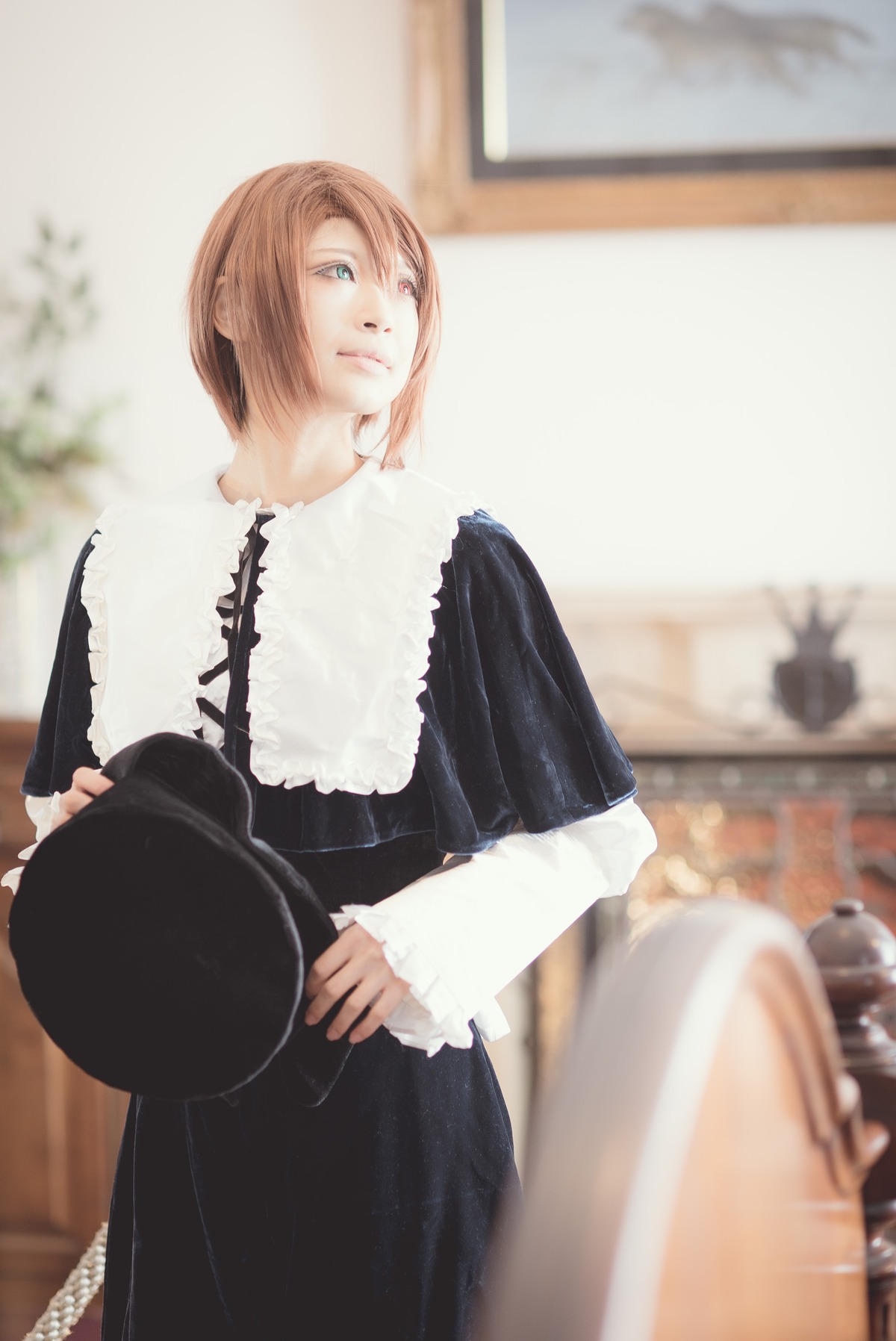black_dress blonde_hair blurry blurry_background blurry_foreground depth_of_field dress frilled_sleeves hat hat_removed headwear_removed holding holding_clothes holding_hat indoors long_sleeves solo souseiseki standing