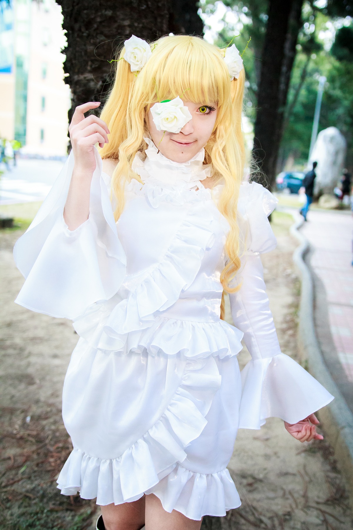 1girl animal_ears bangs blonde_hair blurry blurry_background blurry_foreground day depth_of_field dress eyepatch flower hair_ornament kirakishou lips long_hair looking_at_viewer outdoors photo solo standing white_dress yellow_eyes