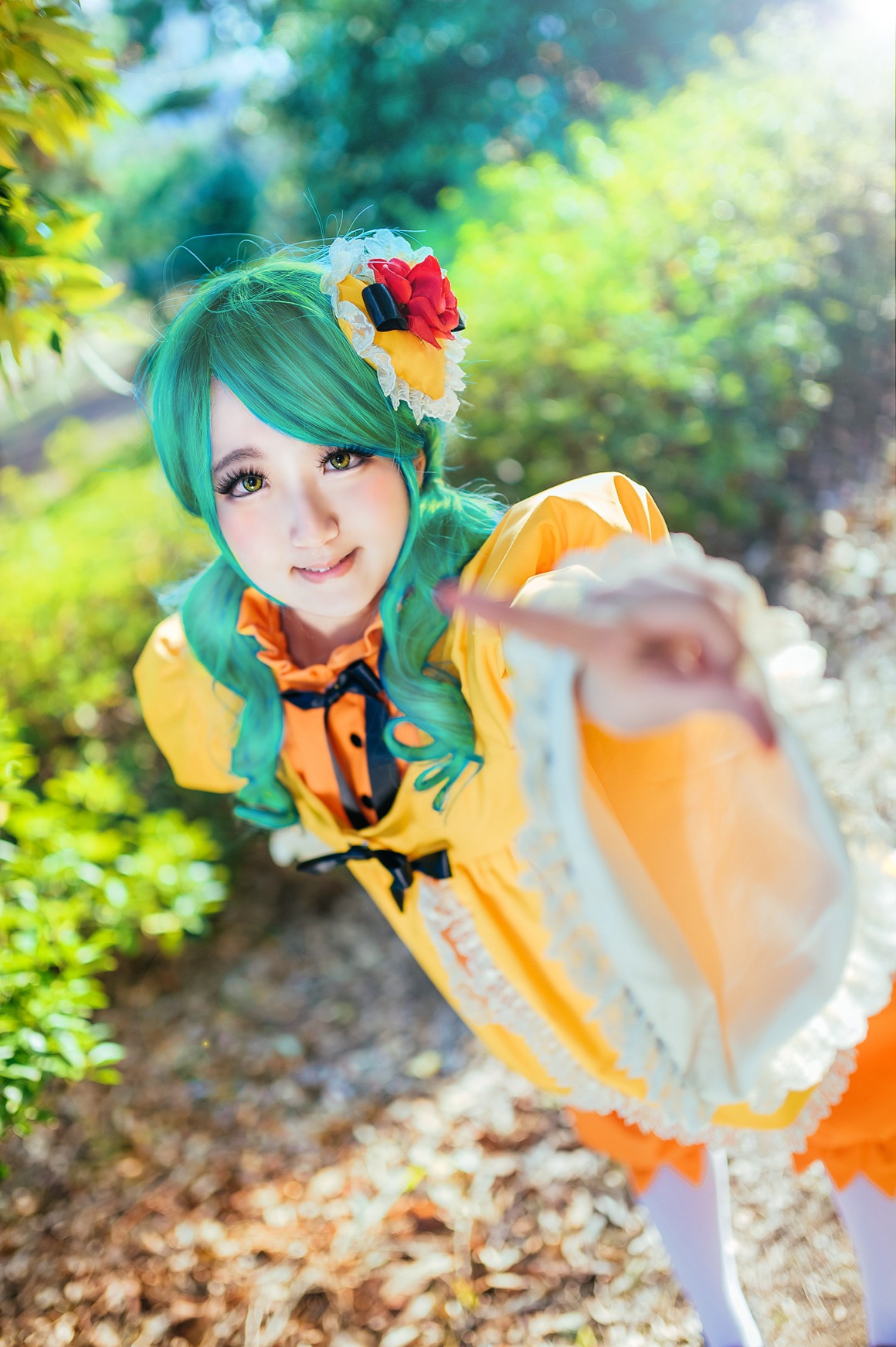 1girl blurry blurry_foreground depth_of_field dress flower foreshortening frills green_eyes green_hair hair_flower hair_ornament kanaria lips looking_at_viewer smile solo